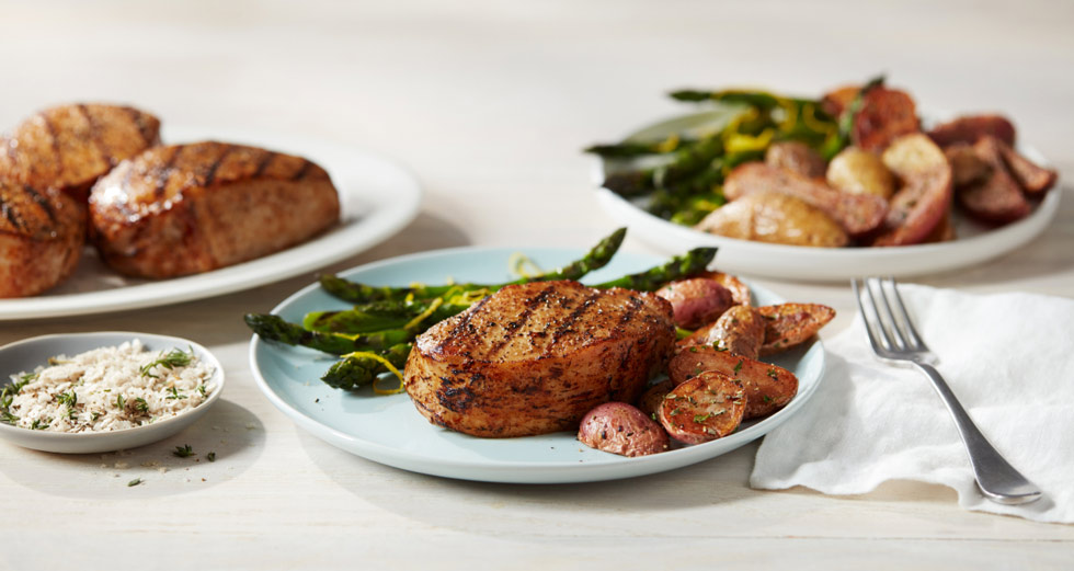 Salt and pepper grilled Tyson pork chops with fingerling potatoes and lemon asparagus